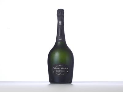 the bottle of champagne is sitting on the table