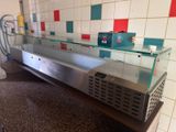 a counter that has a glass display case on top of it