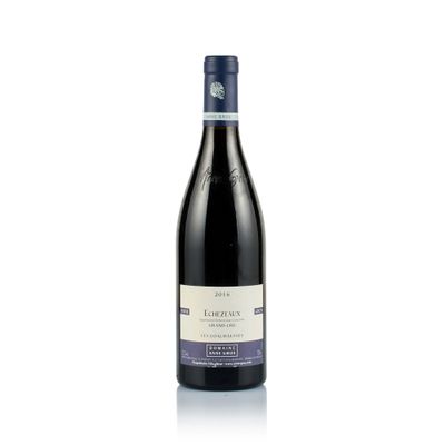 a bottle of wine sitting on top of a white surface