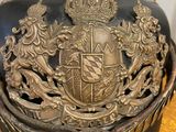 a helmet with a coat of arms on it on a table