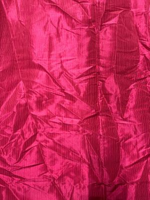 a close up of a pink fabric with a black background