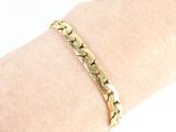 a close up of a person ' s hand wearing a gold bracelet