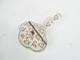 a small metal object with a floral design on it