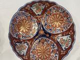 three plates with designs on them sit on a white surface