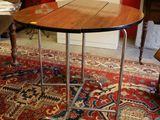 a table with a wooden top on a rug in a room