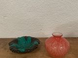 two vases sitting on a wooden table next to each other