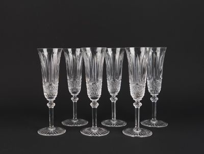 a set of six crystal wine glasses on a black background