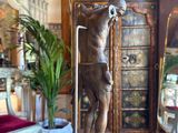 a statue of a man holding a basketball ball in a living room