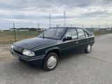 an image of a green car parked in a parking lot