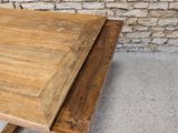 a wooden table with a wooden top on a concrete floor