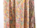 a close up of a multicolored scarf hanging on a clothes rack