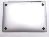 the back of a silver laptop with a small hole in the middle of it