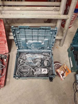 many different tools in a plastic box on the floor