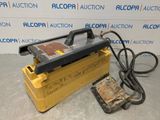 a yellow box sitting on top of a floor next to a power cord