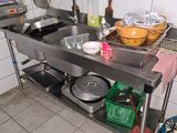 a kitchen with a sink, stove, and other items on the counter