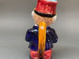 a small figurine of a man with a hat on