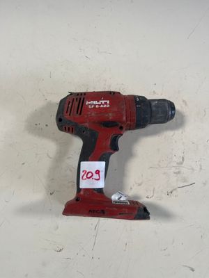 une image représentant une perceuse sans fil posée sur une surface blanche