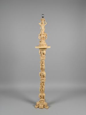 a carved wooden lamp with a bird on top of it