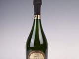 a bottle of champagne on a white surface