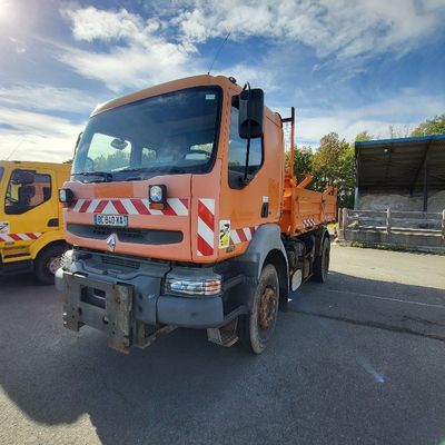 a orange truck that is parked in a parking lot