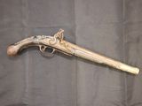 an old gun that is on display on a black cloth