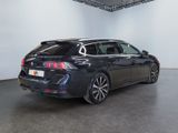 the rear end of a black car in a white room