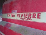 a red and white sign on the side of a train