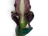 a figurine of a frog sitting on top of a flower