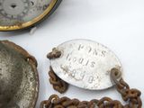 a close up of a clock and a chain on a table