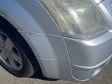 a silver car that is parked in a parking lot