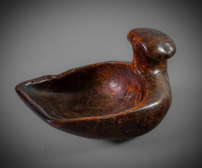 a close up of a wooden bowl with a bird on it