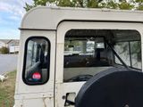 a white truck with a black tire cover in the back