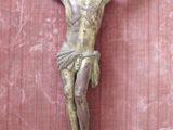 a statue of jesus hanging on the wall of a building
