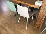 a table and chairs in a room with wood flooring