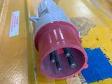 a close up of a red and white plug on a yellow box