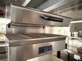 an image of a commercial kitchen with stainless steel appliances