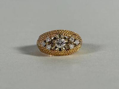 a close up of a gold ring with three diamonds on it
