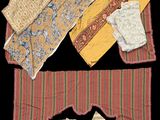 several pieces of cloth are laid out on a black surface