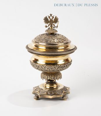 a gold plate with a bird on top of it