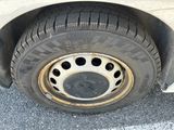 a tire on the side of a car that has a hole in it