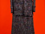 an image of a dress and jacket on a mannequin stand