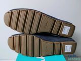 the soles of a pair of shoes are on top of a blue box