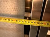 a measuring tape that is on the side of a refrigerator
