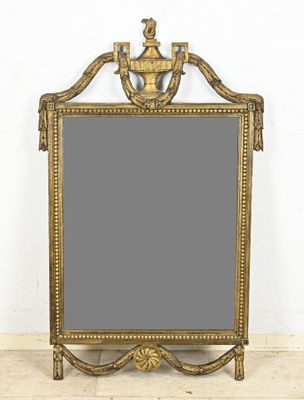 an ornate gold framed mirror with a bird on top