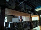 a lot of electronics on a shelf in a room