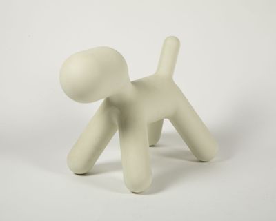 a small white figurine of a dog on a white background