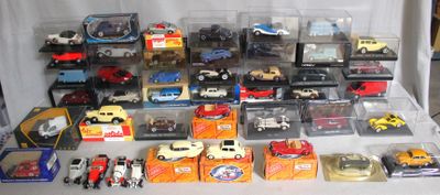 a lot of toy cars and other toys on a table