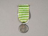 a small medal with a coin on a table