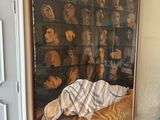 a painting on the wall above a couch in a living room