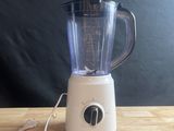 a blender sitting on a wooden table with a black background